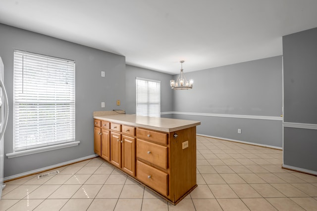 2916 Sandersville Rd, Lexington, KY 40511 - kitchen featuring a peninsula, a chandelier, light countertops, and light tile patterned floors