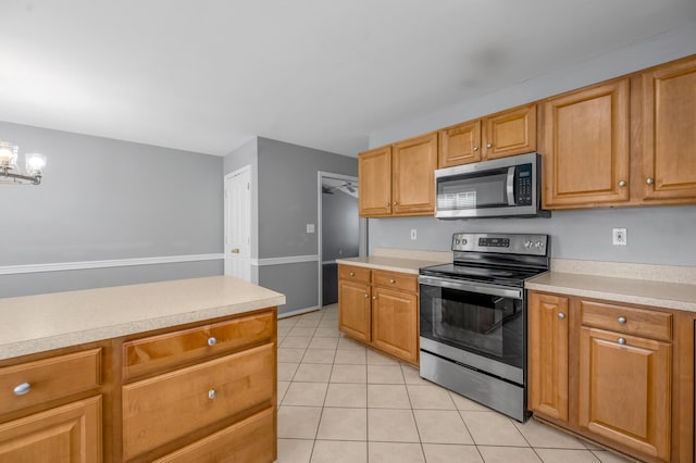 2916 Sandersville Rd, Lexington, KY 40511 - kitchen with appliances with stainless steel finishes, light tile patterned floors, light countertops, and a chandelier
