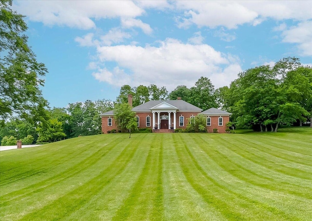 1758 Airdrie Ln, Frankfort, KY 40601 - greek revival inspired property with a front yard, a chimney, view of wooded area, and brick siding