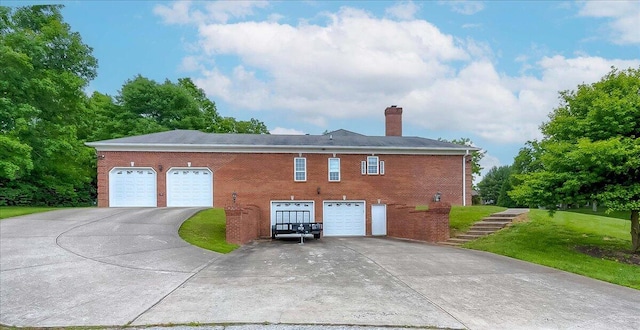 1758 Airdrie Ln, Frankfort, KY 40601 - view of home's exterior with driveway, a garage, a chimney, brick siding, and a lawn