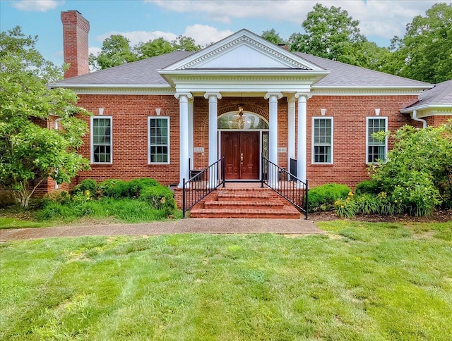 1758 Airdrie Ln, Frankfort, KY 40601 - greek revival house featuring a chimney, brick siding, a front yard, and a shingled roof