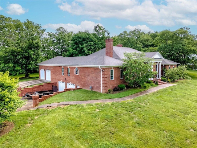 1758 Airdrie Ln, Frankfort, KY 40601 - back of house featuring a chimney, brick siding, a yard, and driveway