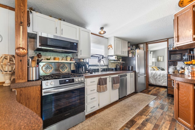 1100 Doublegate Rd, Jeffersonville, KY 40337 - kitchen with stainless steel appliances, a textured ceiling, white cabinetry, dark wood-type flooring, and dark countertops