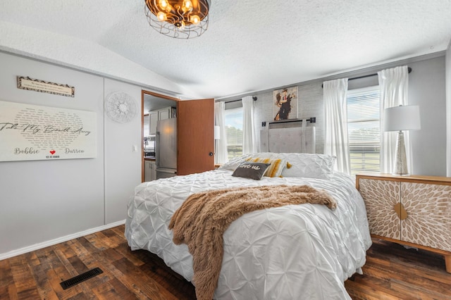 1100 Doublegate Rd, Jeffersonville, KY 40337 - bedroom with wood finished floors, freestanding refrigerator, vaulted ceiling, and a textured ceiling