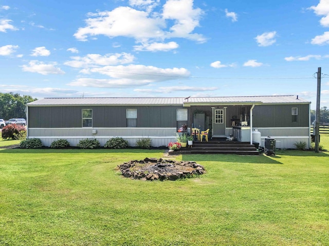 1100 Doublegate Rd, Jeffersonville, KY 40337 - rear view of house featuring a yard, a metal roof, and covered porch