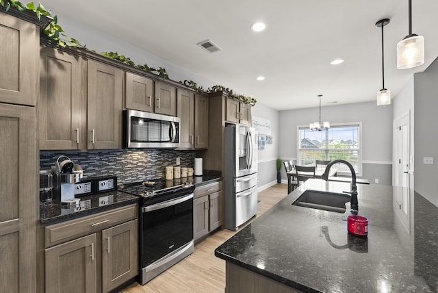 176 Cross Park Dr, Georgetown, KY 40324 - kitchen featuring appliances with stainless steel finishes, backsplash, light wood-style floors, recessed lighting, and a chandelier
