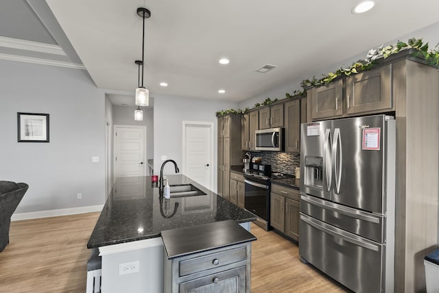 176 Cross Park Dr, Georgetown, KY 40324 - kitchen with appliances with stainless steel finishes, recessed lighting, tasteful backsplash, light wood-style flooring, and an island with sink