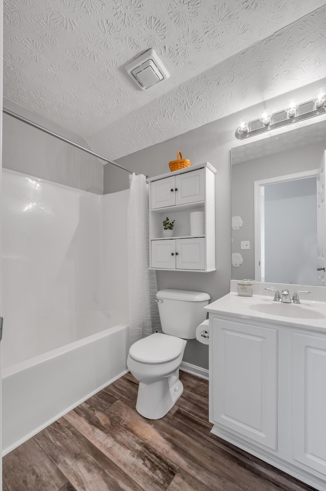 1701 Keating Dr, Louisville, KY 40245 - bathroom with wood finished floors, shower / bathtub combination with curtain, vanity, and a textured ceiling