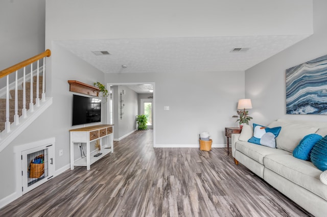 1701 Keating Dr, Louisville, KY 40245 - living area with wood finished floors, stairway, and a textured ceiling