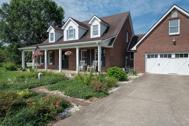 5045 Mccowans Ferry Rd, Versailles, KY 40383 - cape cod house with asphalt driveway, brick siding, and a porch