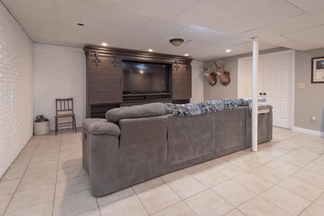 5045 Mccowans Ferry Rd, Versailles, KY 40383 - living area featuring brick wall, light tile patterned floors, and a paneled ceiling