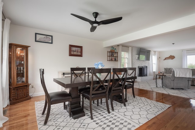 5045 Mccowans Ferry Rd, Versailles, KY 40383 - dining space with ceiling fan, light wood-style floors, and a fireplace