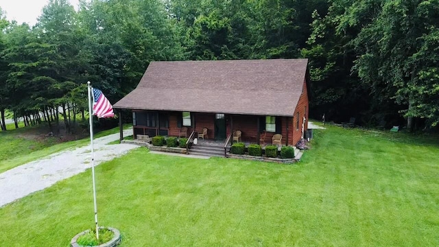709 Carrington Green Rd, Salt Lick, KY 40371 - view of front of property featuring a porch, a front yard, a shingled roof, and a forest view