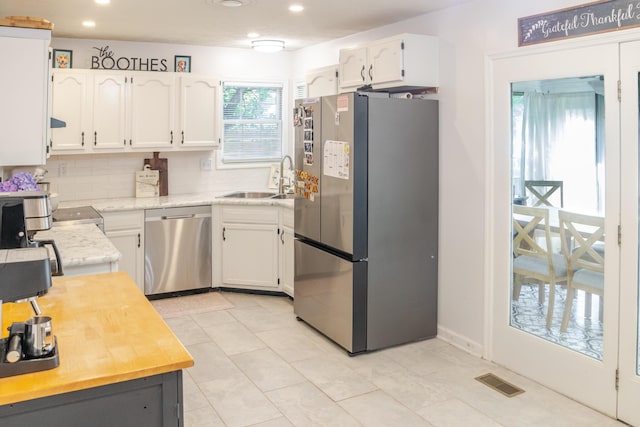 261 Applegrove Dr, Nicholasville, KY 40356 - kitchen featuring appliances with stainless steel finishes, light countertops, white cabinets, recessed lighting, and decorative backsplash