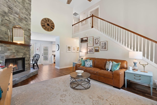 2193 Birkdale Dr, Lexington, KY 40509 - living room featuring wood finished floors, stairs, a towering ceiling, a stone fireplace, and ceiling fan