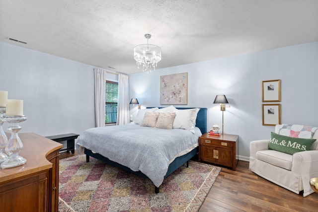 2193 Birkdale Dr, Lexington, KY 40509 - bedroom with wood finished floors, a chandelier, and a textured ceiling