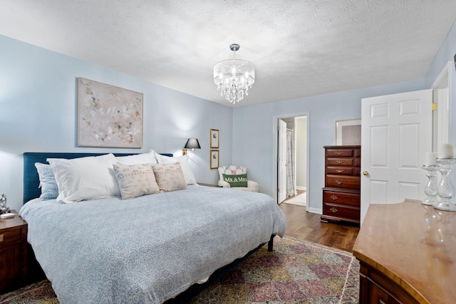 2193 Birkdale Dr, Lexington, KY 40509 - bedroom with dark wood finished floors, a chandelier, and a textured ceiling