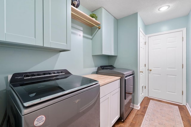 2193 Birkdale Dr, Lexington, KY 40509 - laundry area featuring cabinet space, light wood-style flooring, a textured ceiling, washing machine and dryer, and recessed lighting