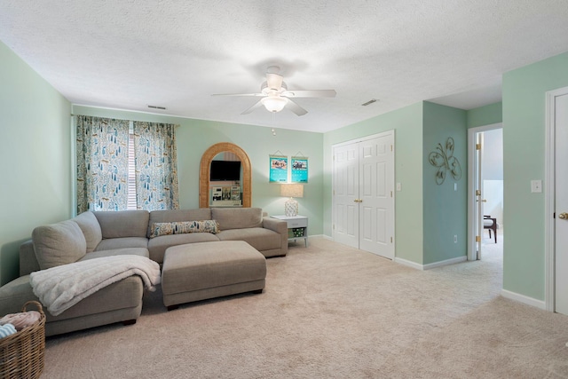 2193 Birkdale Dr, Lexington, KY 40509 - living room featuring carpet floors, ceiling fan, arched walkways, and a textured ceiling