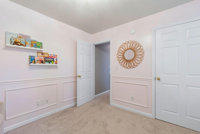 2193 Birkdale Dr, Lexington, KY 40509 - bedroom with carpet flooring, a textured ceiling, and a wainscoted wall