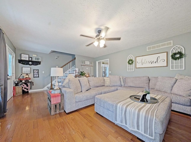 109 Edwards Ct, Lancaster, KY 40444 - living room featuring ceiling fan, stairs, wood finished floors, and a textured ceiling