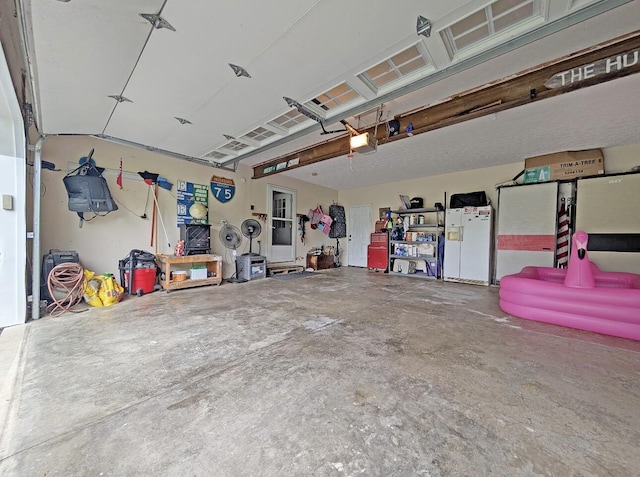 109 Edwards Ct, Lancaster, KY 40444 - garage with a garage door opener and white refrigerator with ice dispenser