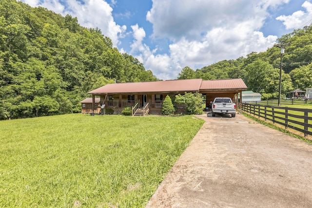 30 Country Ln, Prestonsburg, KY 41653 - ranch-style home featuring concrete driveway, covered porch, a wooded view, a metal roof, and a carport