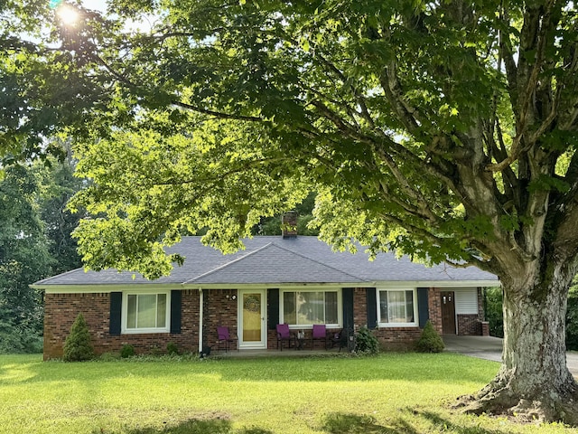 2492 Willailla Rd, Brodhead, KY 40409 - ranch-style house with brick siding, a front lawn, roof with shingles, and concrete driveway