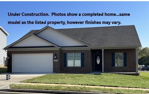 108 Aetna, Georgetown, KY 40324 - view of front of property featuring an attached garage, concrete driveway, brick siding, and a front lawn