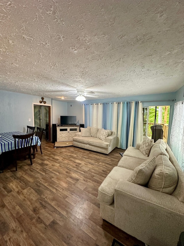 449 Johns Rd, Jabez, KY 42544 - living room featuring a textured ceiling, dark wood-type flooring, and a ceiling fan