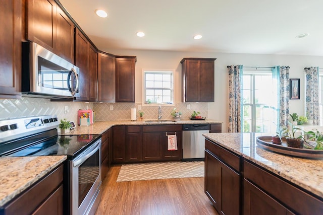 126 Mollie Way, Georgetown, KY 40324 - kitchen featuring stainless steel appliances, light wood-style floors, plenty of natural light, backsplash, and recessed lighting