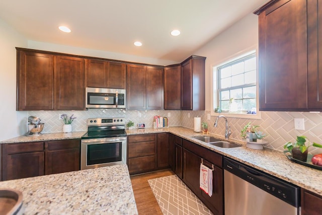 126 Mollie Way, Georgetown, KY 40324 - kitchen with stainless steel appliances, light stone countertops, tasteful backsplash, wood finished floors, and recessed lighting