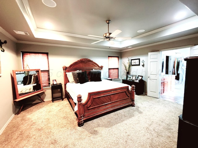 bedroom featuring light colored carpet, ornamental molding, and a raised ceiling