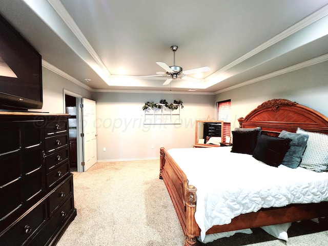 bedroom featuring light colored carpet, baseboards, crown molding, and a raised ceiling