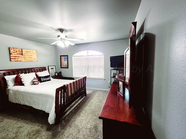 carpeted bedroom with baseboards and a ceiling fan
