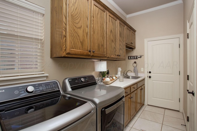 7705 New England Pkwy, Amarillo, TX 79119 - laundry area featuring light tile patterned floors, cabinet space, ornamental molding, a sink, and washing machine and dryer