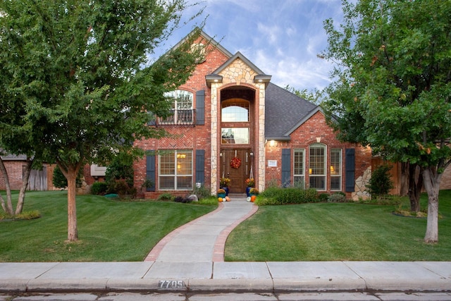 7705 New England Pkwy, Amarillo, TX 79119 - traditional-style house with brick siding, a front yard, and roof with shingles