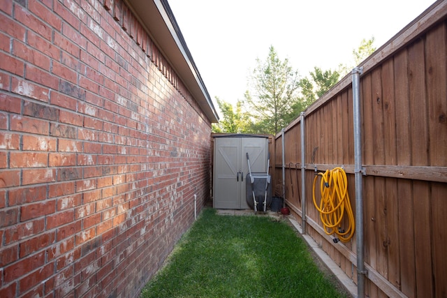 7705 New England Pkwy, Amarillo, TX 79119 - view of property exterior featuring brick siding, fence, an outdoor structure, and a shed