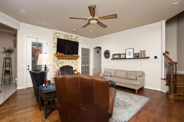 7705 New England Pkwy, Amarillo, TX 79119 - living room featuring arched walkways, ornamental molding, a stone fireplace, visible vents, and a ceiling fan