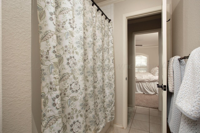 7705 New England Pkwy, Amarillo, TX 79119 - full bath featuring tile patterned floors, curtained shower, crown molding, and ensuite bath