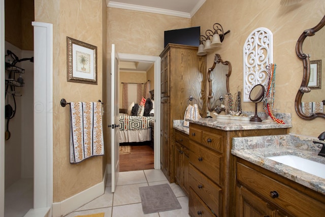 7705 New England Pkwy, Amarillo, TX 79119 - ensuite bathroom with vanity, connected bathroom, crown molding, baseboards, and tile patterned flooring