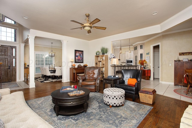 7705 New England Pkwy, Amarillo, TX 79119 - living area with light wood-style flooring, baseboards, ornamental molding, ornate columns, and ceiling fan with notable chandelier