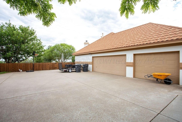 6106 Purple Sage Cir, Amarillo, TX 79124 - view of side of property with fence, stucco siding, a chimney, and concrete driveway