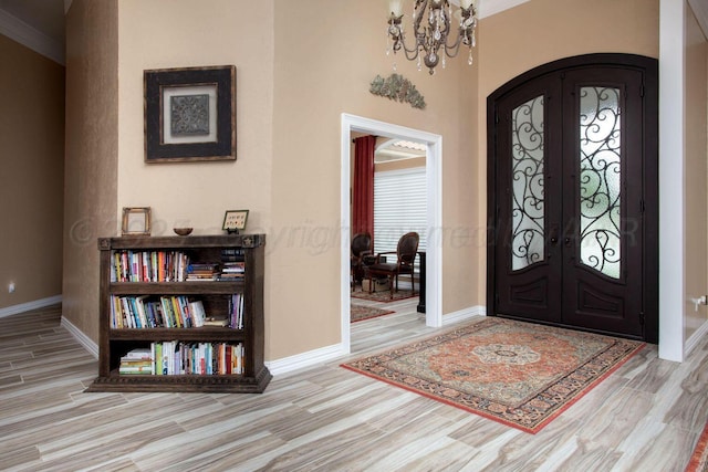 6106 Purple Sage Cir, Amarillo, TX 79124 - entryway with french doors, wood finished floors, arched walkways, a chandelier, and baseboards