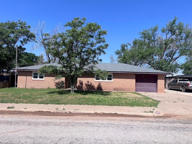 109 Ranger St, Hereford, TX 79045 - ranch-style home featuring a garage, concrete driveway, a front yard, and brick siding