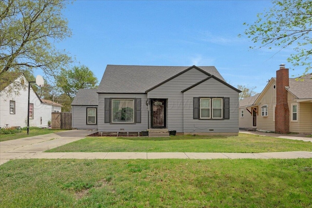 bungalow-style house with a front yard and a shingled roof