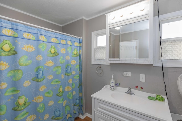 bathroom featuring vanity, curtained shower, and crown molding