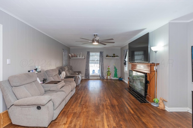 living room featuring crown molding, wooden walls, dark hardwood / wood-style floors, and ceiling fan