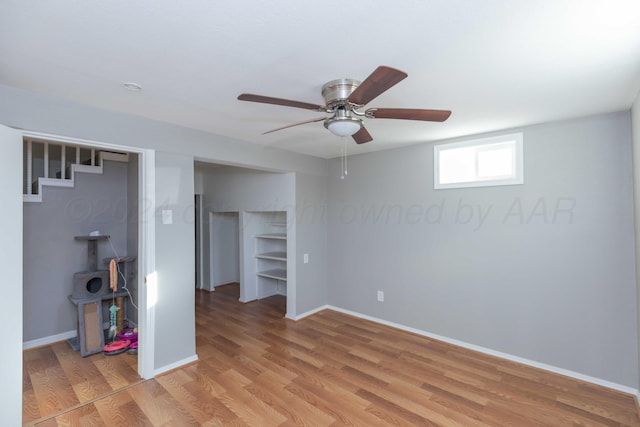 unfurnished bedroom with ceiling fan and light wood-type flooring