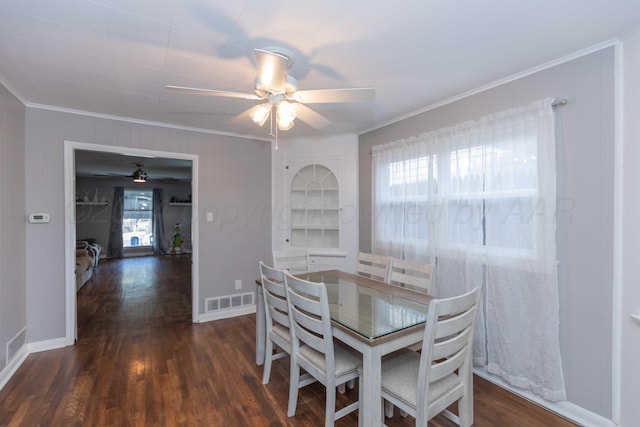 dining room featuring a wealth of natural light, ceiling fan, and dark hardwood / wood-style flooring